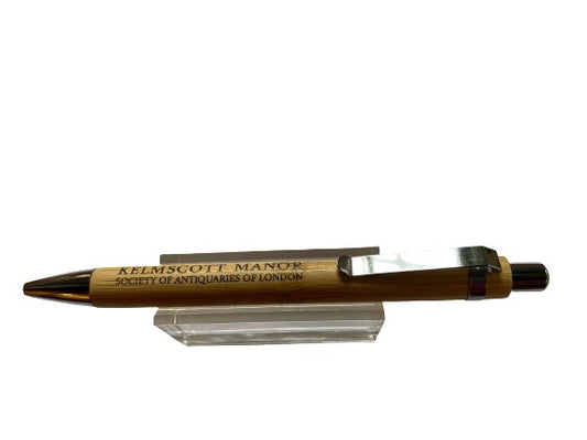 A bamboo ballpoint pen inscribed with the wording Kelmscott Manor.  Ink colour is blue